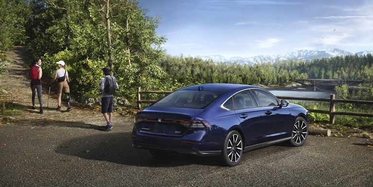2026 Honda Accord 3/4 rear view parked in a turnout for a trailhead.